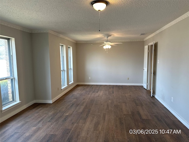 unfurnished room featuring visible vents, dark wood-style floors, crown molding, baseboards, and ceiling fan