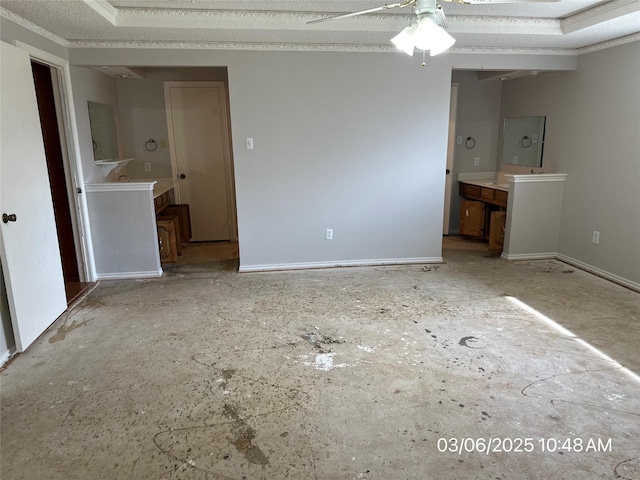 interior space featuring a ceiling fan and baseboards