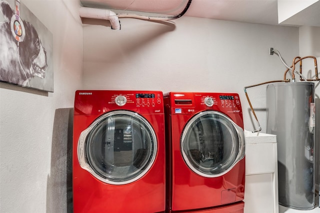 laundry room featuring electric water heater, laundry area, and washer and clothes dryer