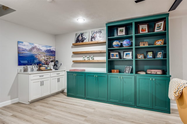 bar with light wood-style flooring and baseboards