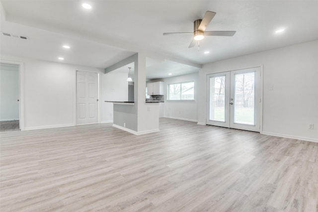 unfurnished living room with visible vents, baseboards, light wood-type flooring, recessed lighting, and french doors