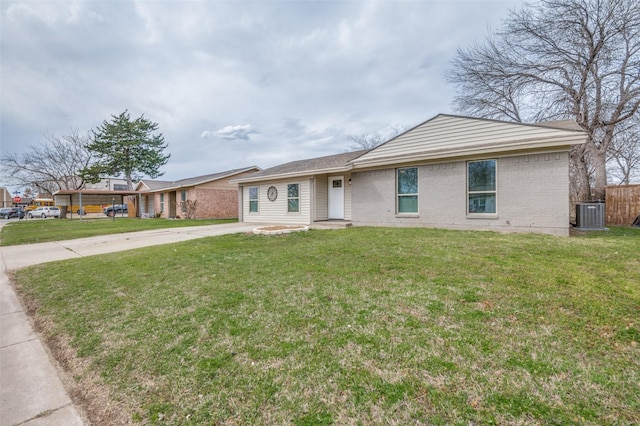 ranch-style house featuring brick siding, concrete driveway, a front yard, and fence