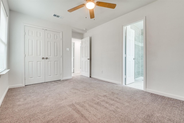 unfurnished bedroom featuring a closet, visible vents, baseboards, and carpet