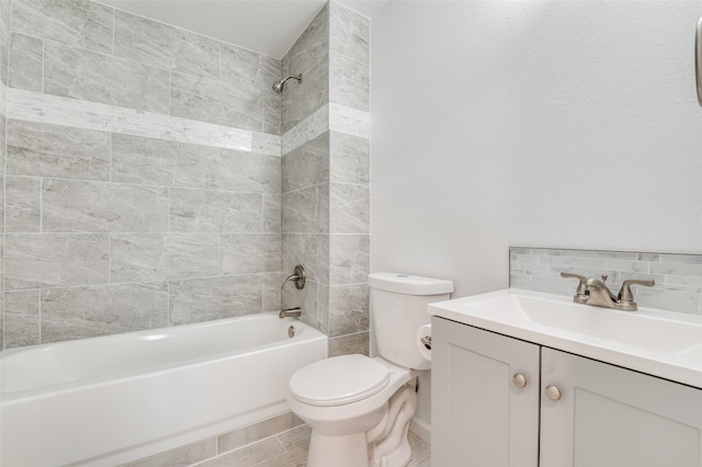 bathroom featuring backsplash, vanity, toilet, and  shower combination