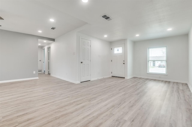 unfurnished living room with recessed lighting, visible vents, and light wood finished floors