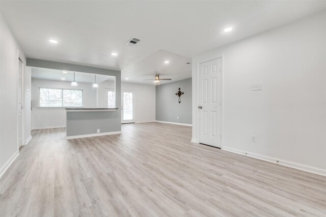 unfurnished living room with baseboards, visible vents, recessed lighting, ceiling fan, and light wood-type flooring