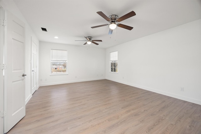 spare room featuring light wood finished floors, visible vents, baseboards, recessed lighting, and a ceiling fan