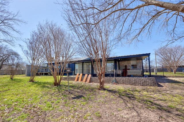 back of property featuring a deck, a yard, and fence