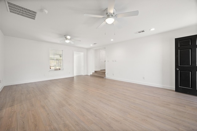 unfurnished living room featuring light wood finished floors, visible vents, ceiling fan, and baseboards