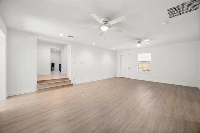 spare room with visible vents, ceiling fan, baseboards, and light wood-style floors