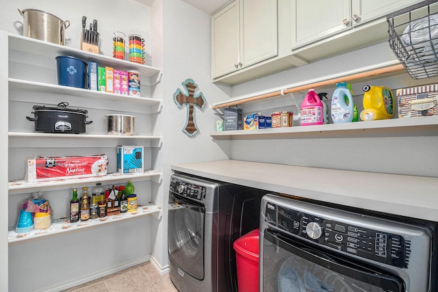 laundry room with baseboards, cabinet space, washing machine and dryer, and light tile patterned flooring