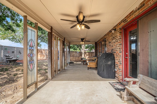 view of patio / terrace with grilling area, a fenced backyard, and ceiling fan