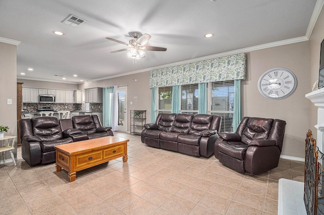 living room featuring visible vents, a fireplace with raised hearth, ornamental molding, light tile patterned flooring, and baseboards