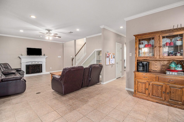 living area with baseboards, light tile patterned flooring, a fireplace with raised hearth, ornamental molding, and stairs