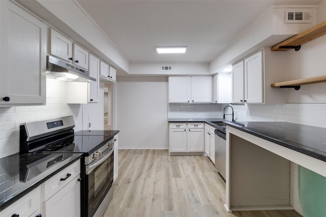 kitchen with visible vents, open shelves, under cabinet range hood, appliances with stainless steel finishes, and a sink