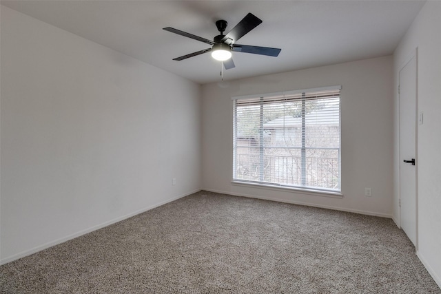 carpeted empty room with a ceiling fan