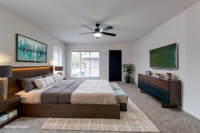 bedroom featuring light carpet and ceiling fan