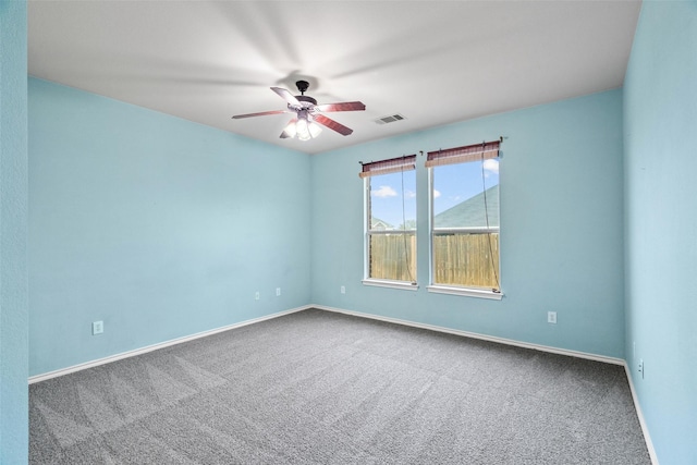 spare room featuring baseboards, visible vents, carpet floors, and ceiling fan