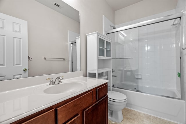 full bathroom with tile patterned floors, visible vents, toilet, combined bath / shower with glass door, and vanity