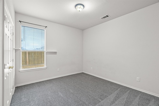 carpeted empty room with visible vents and baseboards