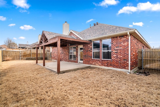 back of property featuring a patio area, brick siding, and a fenced backyard