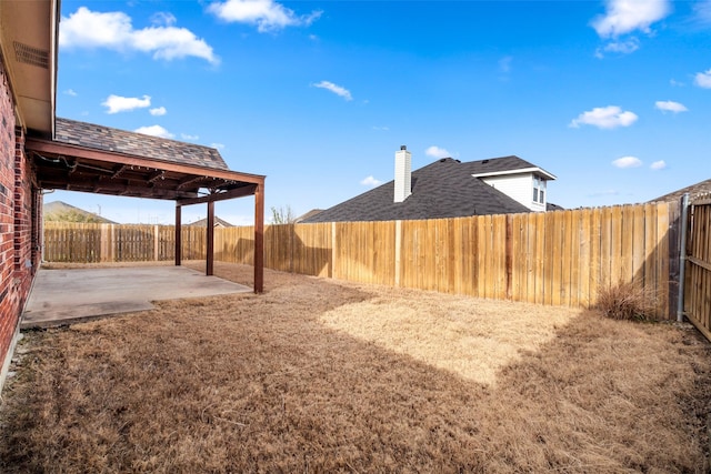 view of yard featuring a patio area and a fenced backyard