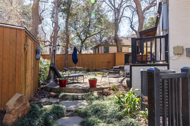 view of yard with a patio, outdoor dining area, and fence