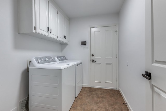 clothes washing area featuring baseboards, cabinet space, visible vents, and washing machine and dryer