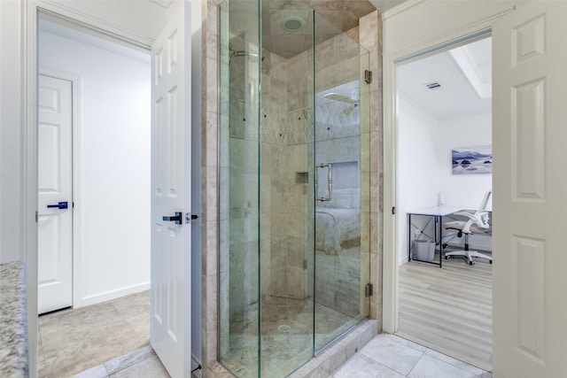 bathroom featuring visible vents, baseboards, a stall shower, tile patterned flooring, and crown molding