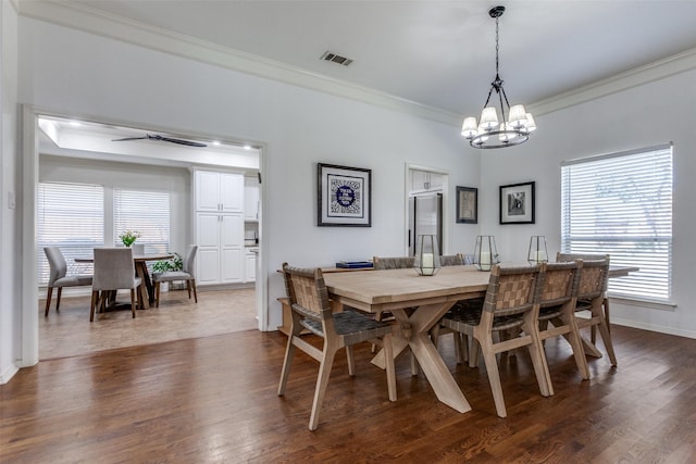 dining room featuring a chandelier, visible vents, dark wood-style flooring, and ornamental molding