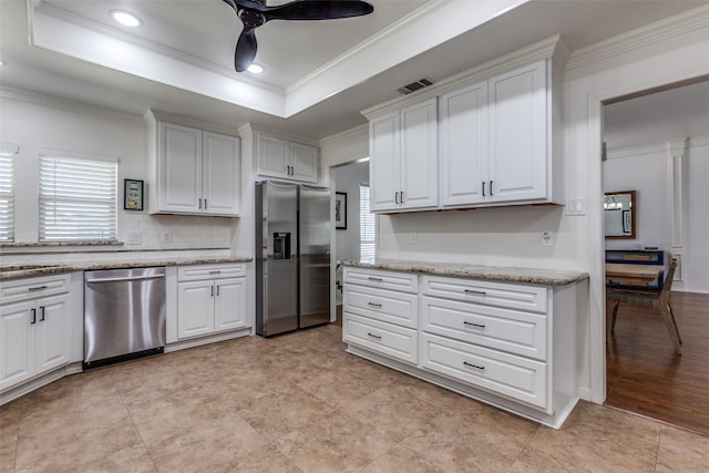 kitchen with visible vents, a tray ceiling, ceiling fan, appliances with stainless steel finishes, and white cabinetry