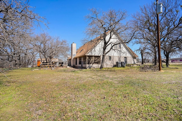 view of yard featuring central AC and a sunroom