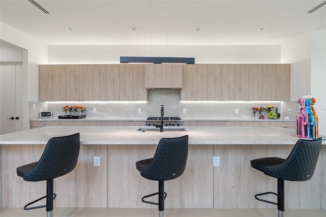 kitchen featuring light brown cabinetry and modern cabinets