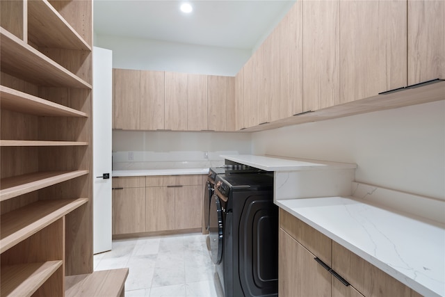 laundry room with cabinet space and washer and clothes dryer