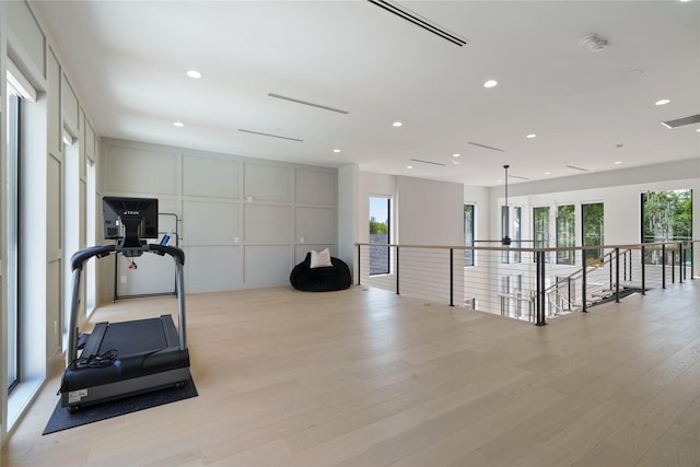 exercise area with recessed lighting, visible vents, and wood finished floors