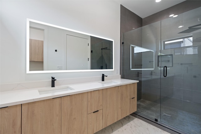 bathroom with a sink, marble finish floor, a shower stall, and double vanity