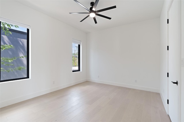 empty room featuring ceiling fan, baseboards, and light wood-style flooring