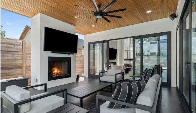 view of patio featuring an outdoor living space with a fireplace and ceiling fan