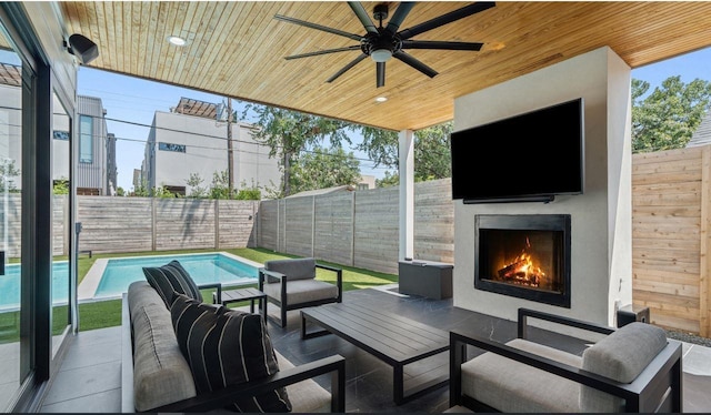 view of patio / terrace with an outdoor living space with a fireplace, a fenced in pool, a fenced backyard, and ceiling fan