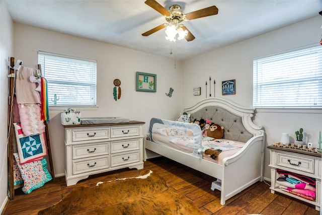 bedroom featuring dark wood-type flooring and a ceiling fan