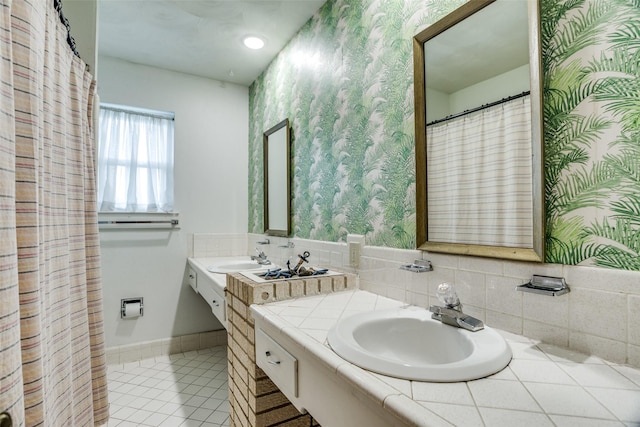 full bath featuring tile patterned floors, wallpapered walls, and vanity