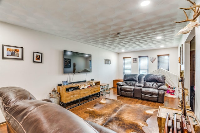 living room featuring recessed lighting, visible vents, and wood finished floors