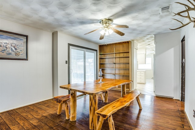 dining area with visible vents, a healthy amount of sunlight, crown molding, and wood-type flooring