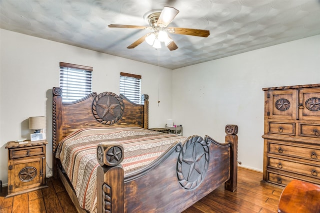 bedroom featuring dark wood finished floors, ceiling fan, and baseboards