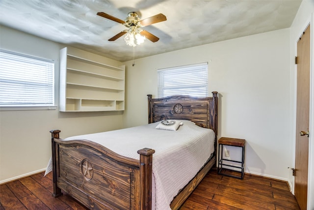 bedroom featuring baseboards, multiple windows, and hardwood / wood-style flooring