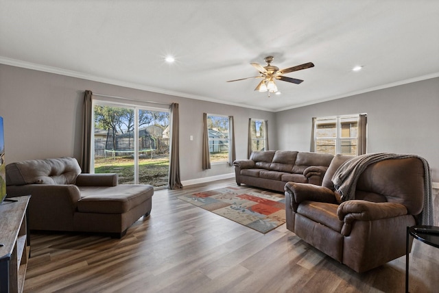 living area featuring recessed lighting, baseboards, ornamental molding, and dark wood-style flooring