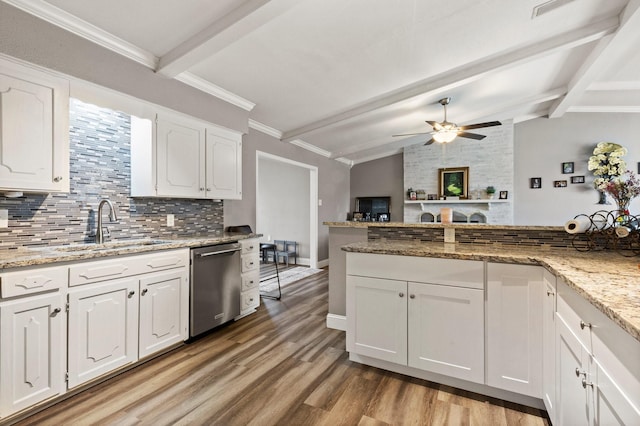 kitchen with lofted ceiling with beams, light wood-style flooring, white cabinets, stainless steel dishwasher, and tasteful backsplash