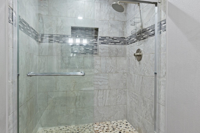 full bath featuring a shower stall