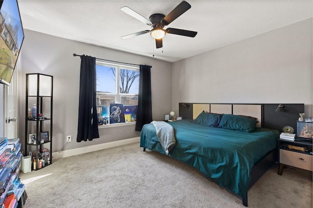 carpeted bedroom featuring ceiling fan and baseboards