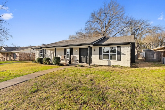 single story home with brick siding, fence, a front yard, covered porch, and a chimney